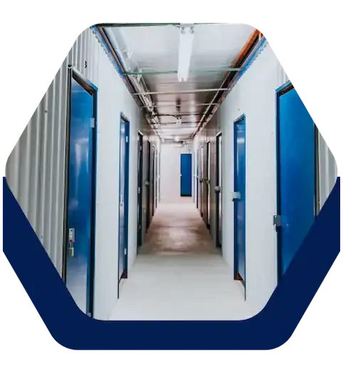 Indoor hallway of climate-controlled storage units with blue doors at Battle Creek Storage in Broken Arrow, OK